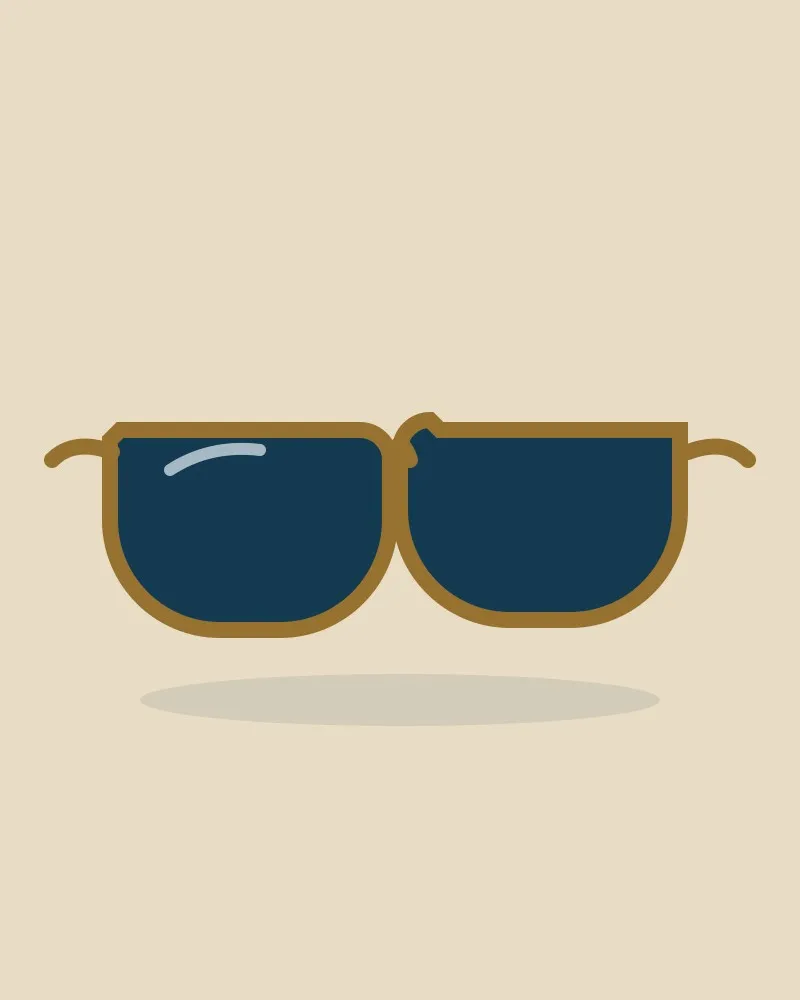 Lunettes de soleil à verres foncés et monture dorée